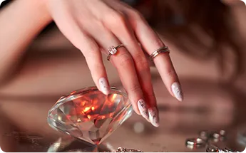 Beauty woman holds big diamond hand while lying table